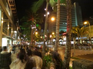 Busy Sidewalk at Night in Waikiki, Hawaii