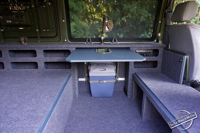 Interior of the Campervan with installed Table, Cool Box and Army Lamp